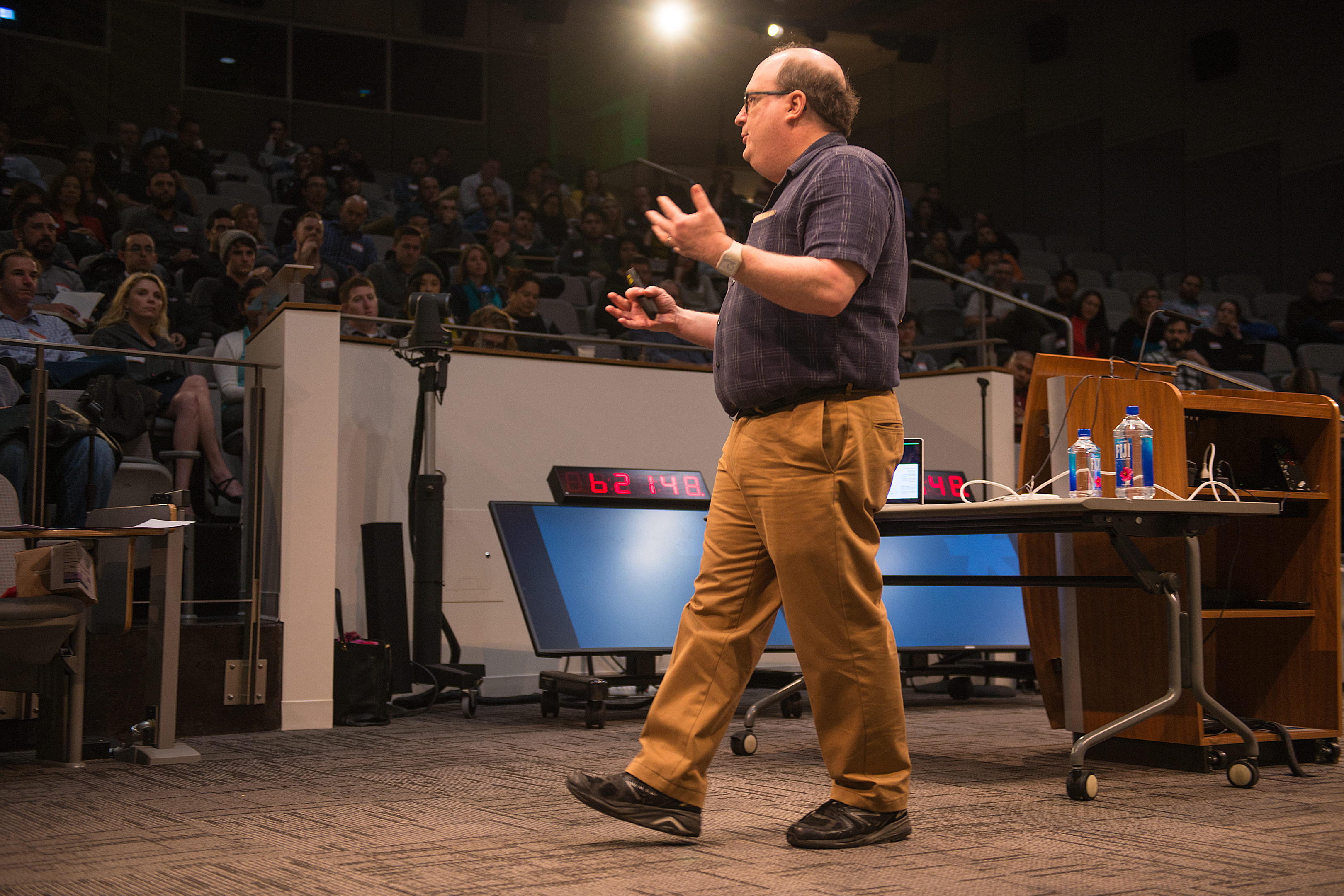 A UX Speakeasy speaker presenting to a full audience